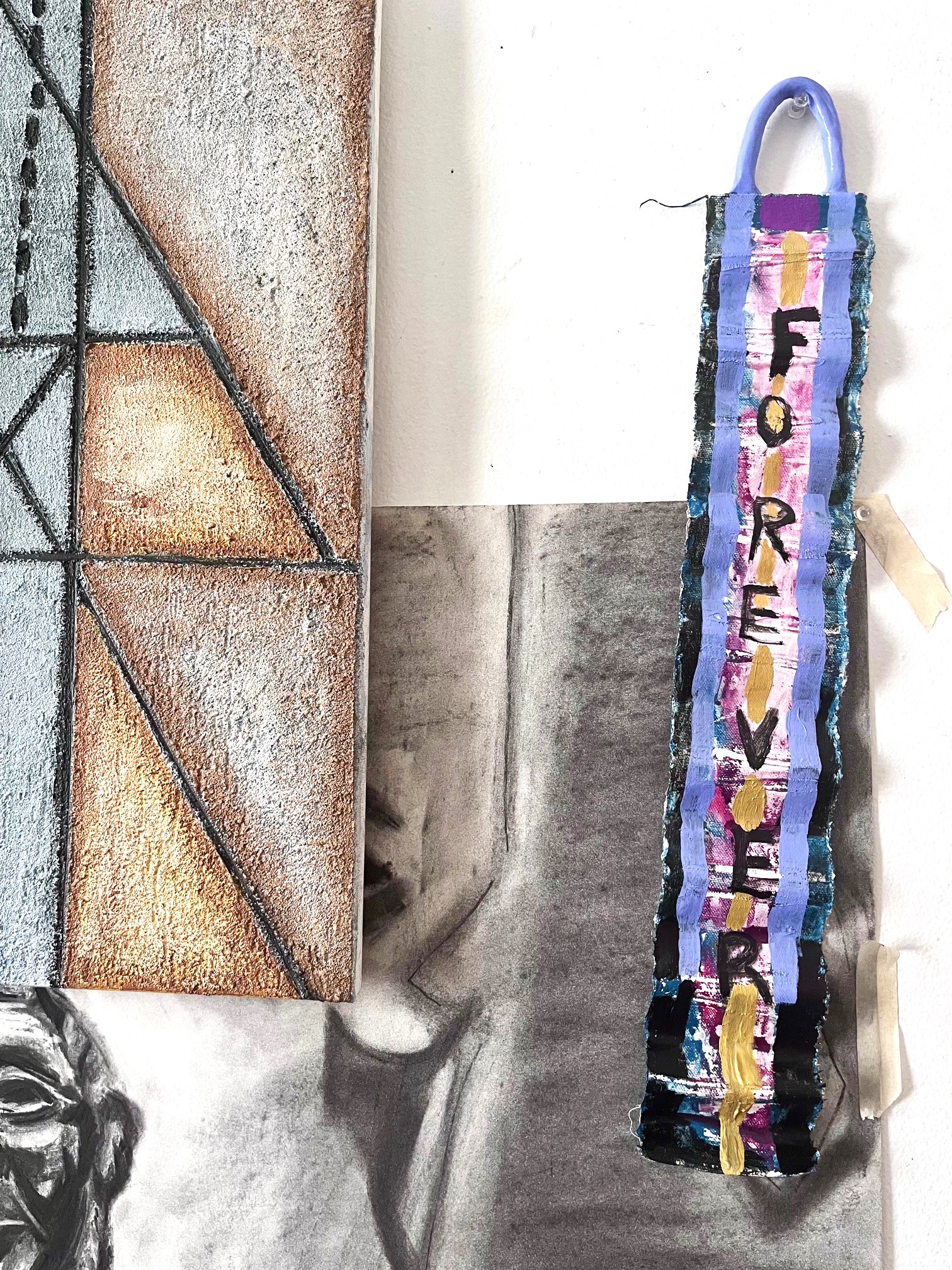 Narrow painting/wall hanging with periwinkle clay hanging with the word FOREVER