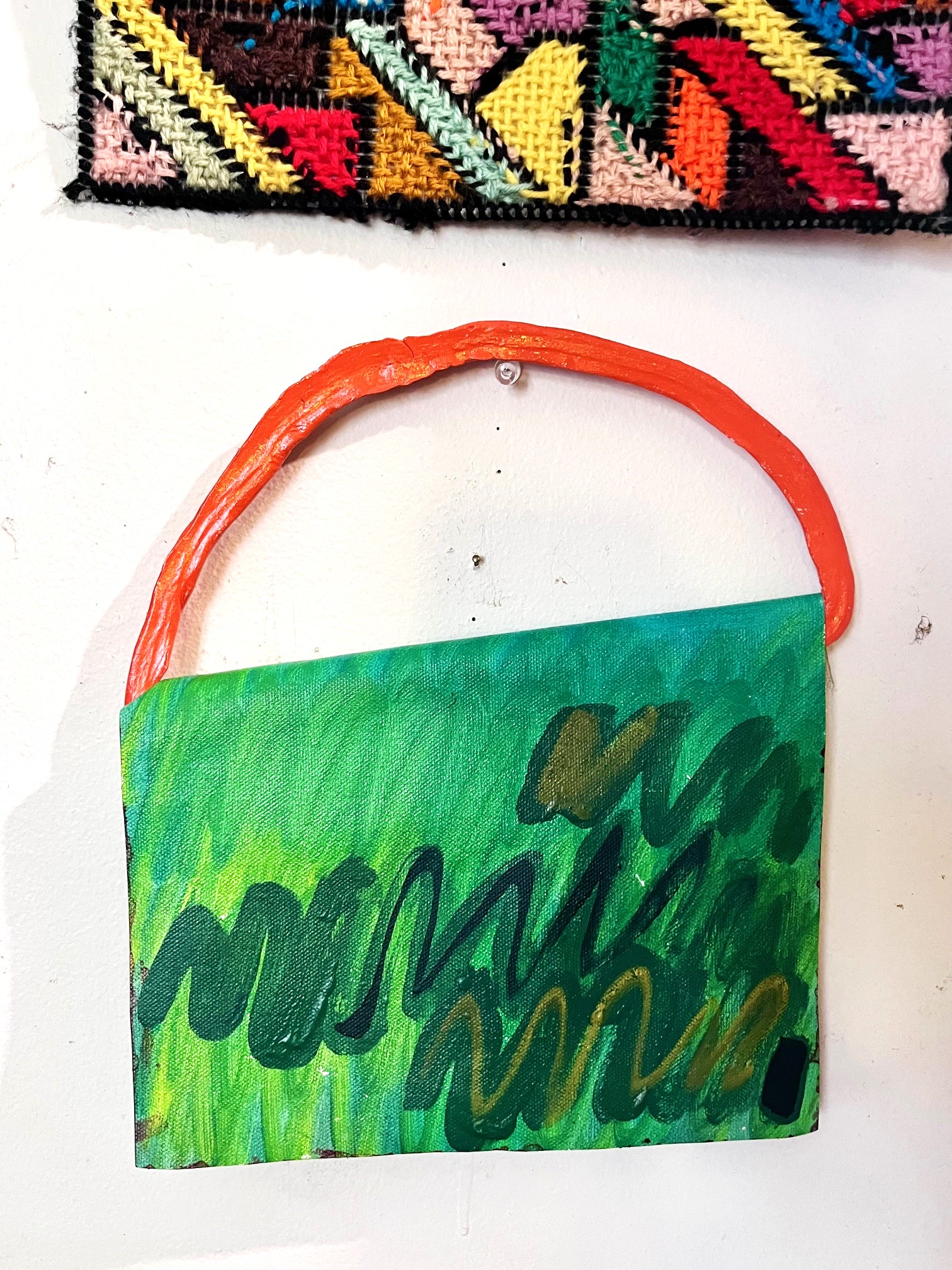 Backside of the Colorblock Flap painting in green with grassy squiggles